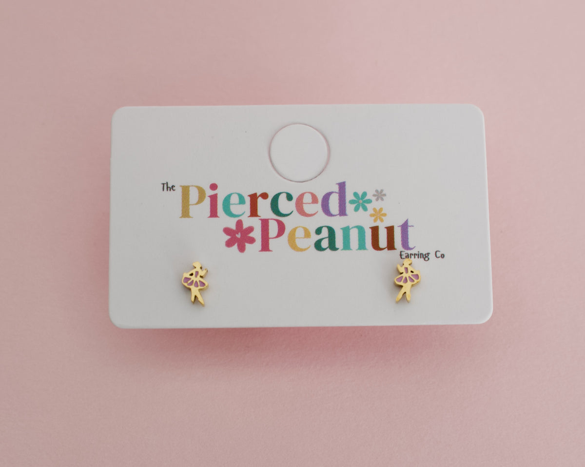 A pair of kids small hypoallergenic gold-tone screwback stud earrings with pink enamel and a yellow flower detail, displayed on a white backing card printed with 'The Pierced Peanut Earring Co' on a soft pink background.