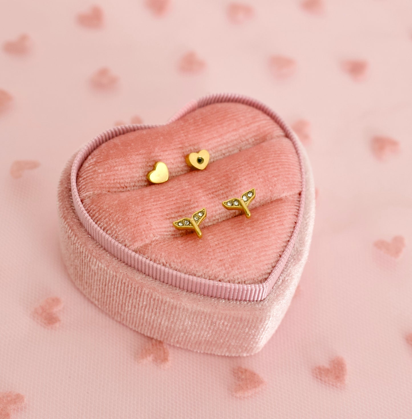 A Pair of kids hypoallergenic screwback stud earrings shaped as mermaid tails from The Pierced Peanut earring company