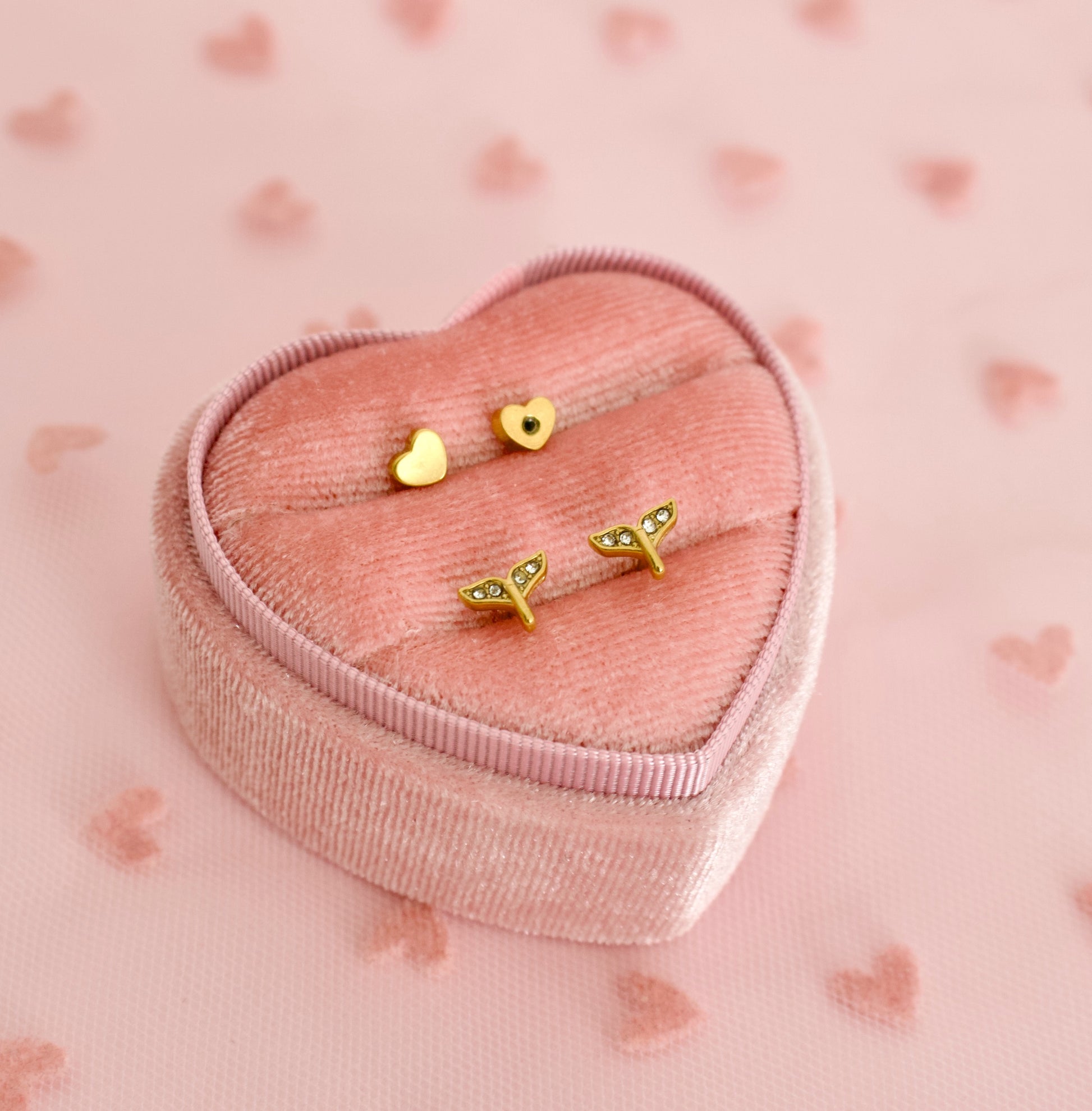 A Pair of kids hypoallergenic screwback stud earrings shaped as mermaid tails from The Pierced Peanut earring company