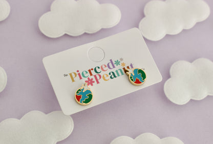 A pair of kids small hypoallergenic round gold-tone screwback stud earrings with colorful enamel details, displayed on a white cloud-shaped stand against a soft lavender background with white cloud cutouts from The Pierced Peanut Earring Co.
