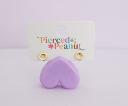 A pair of kids hypoallergenic gold open circle/halo screwback studs , displayed on a white backing card that reads 'The Pierced Peanut Earring Co'.