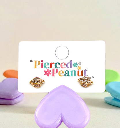 Hypoallergenic planet shaped screwback earrings on a 'The Pierced Peanut' branded card with colorful text.