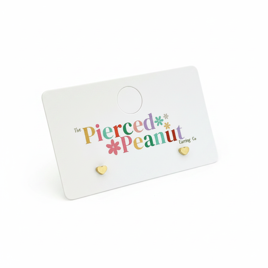 Dainty heart stud earrings on white background