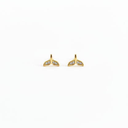 Diamond mermaid tail stud earrings on white background